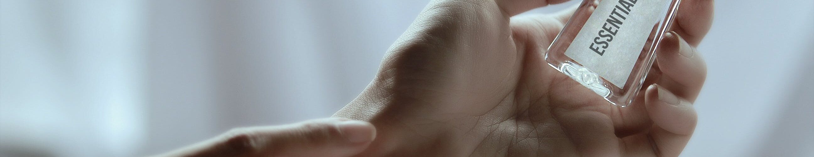 hand-holding-essential-oil-bottle