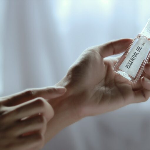 hand-holding-essential-oil-bottle